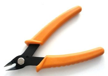 Side cutter with hardened cheeks and plastic handles